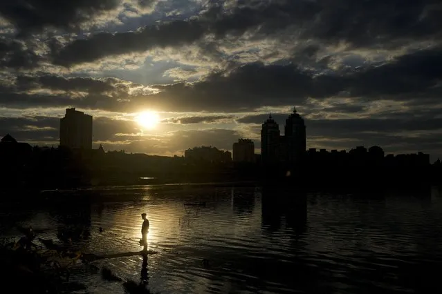 A man stands in Natalka Park in Kyiv, Ukraine, Tuesday, June 7, 2022. (Photo by Natacha Pisarenko/AP Photo)