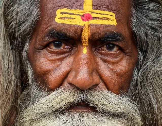 A Sadhu or a Hindu holyman, waits before registering for the annual pilgrimage to the Amarnath cave shrine, at a base camp in Jammu, India, July 2, 2016. (Photo by Mukesh Gupta/Reuters)