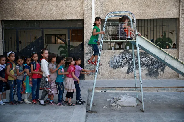 Students play in a playground at a school in Douma, near Damascus, Syria August 16, 2017. (Photo by Bassam Khabieh/Reuters)