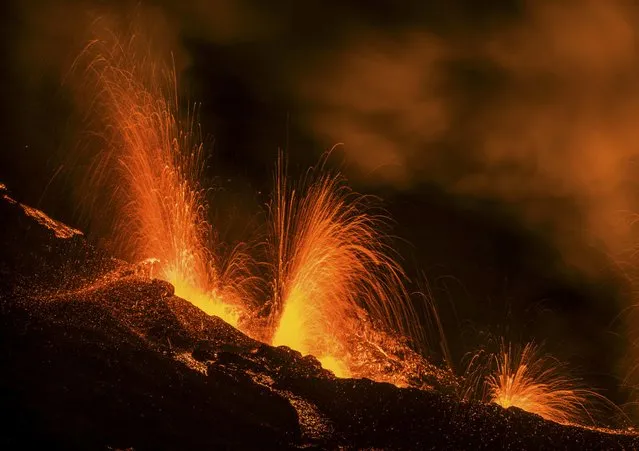 Molten lava erupts from the Piton de la Fournaise, one of the world's most active volcanoes, on the French Indian Ocean Reunion Island, August 25, 2015. (Photo by Gilles Adt/Reuters)