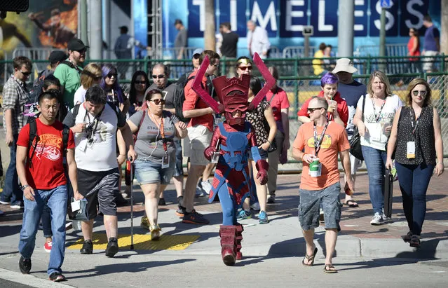 Bunny Knowble, dressed Galactus Eater of Worlds, crosses the street with the crowd on the way to Preview Night at Comic-Con International held at the San Diego Convention Center Wednesday July 20, 2016, in San Diego. (Photo by Denis Poroy/Invision/AP Photo)