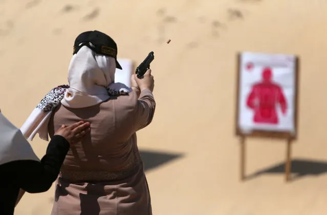 A Palestinian woman fires at a target during a training session for the families of Hamas officials, organized by Hamas-run Security and Protection Service, in Khan Younis in the southern Gaza Strip July 24, 2016. (Photo by Ibraheem Abu Mustafa/Reuters)