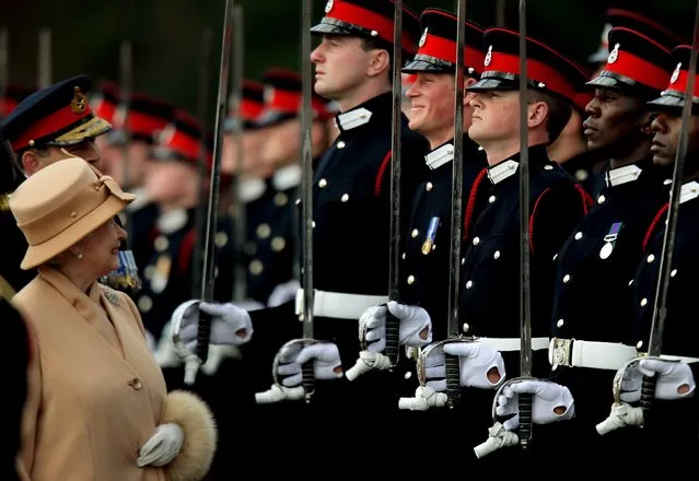 Britain's Queen Elizabeth smiles with Prince Harry during the Sovereign's Parade at the Royal Military Academy in Sandhurst, England, in this April 12, 2006 file photo. The Queen is expected to become the longest serving British monarch on September 9, 2015. She will pass the record set by her great-great-grandmother Queen Victoria with more than 63 years on the throne. (Photo by Dylan Martinez/Reuters)