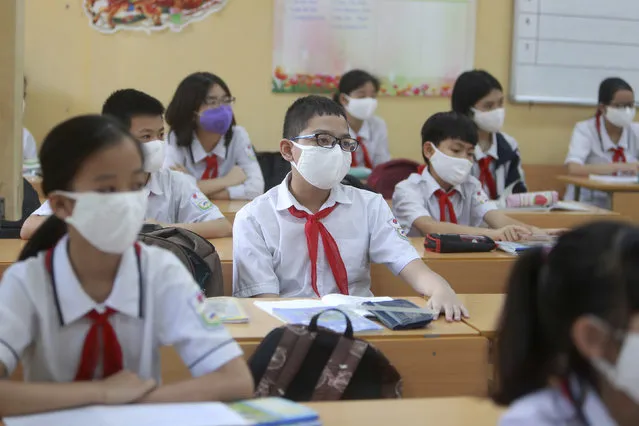 Students wearing masks attend a class in Dinh Cong secondary school in Hanoi, Vietnam Monday, May 4, 2020. Students across Vietnam return to school after three months of studying online due to school closure to contain the spread of COVID-19. (Photo by Hau Dinh/AP Photo)