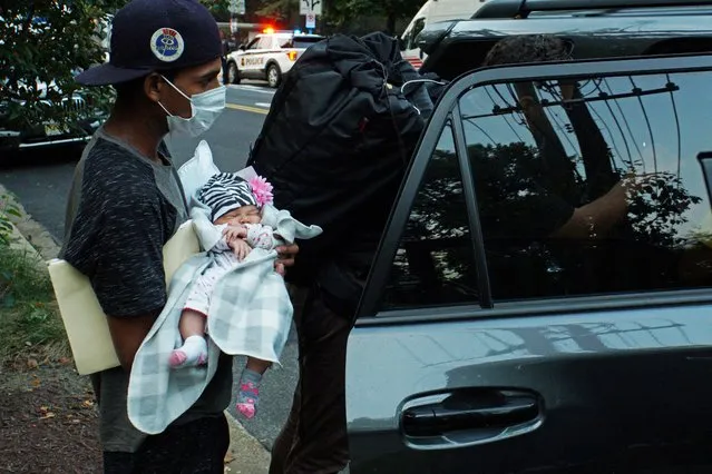A one month old baby is placed into a vehicle for transport to a safe place after a group of mainly Venezuelan migrants, who were sent by bus from detention in Texas, were dropped off outside the Naval Observatory, the official residence of U.S. Vice President Kamala Harris in Washington, U.S. September 17, 2022. (Photo by Marat Sadana/Reuters)