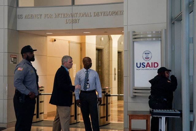 Security personnel work, as the USAID building sits closed to employees after a memo was issued advising agency personnel to work remotely, in Washington, D.C., U.S., February 3, 2025. (Photo by Kent Nishimura/Reuters)