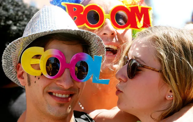 Revellers celebrate during the Street Parade dance music event in Zurich, Switzerland August 13, 2016. (Photo by Arnd Wiegmann/Reuters)