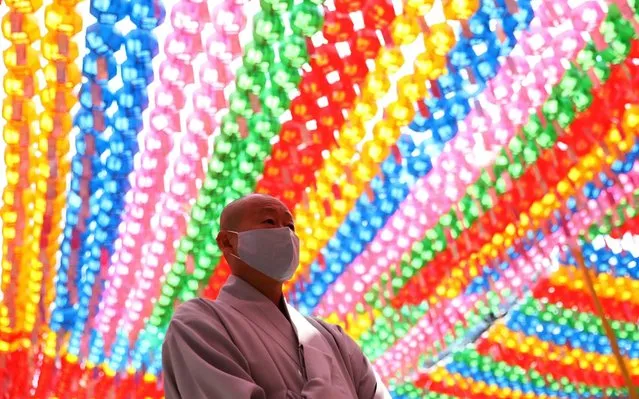A buddhist monk wears mask as a preventive measure against the coronavirus (COVID-19), as he attends a ceremony of Buddha's birthday at Jogyesa Temple on May 30, 2020 in Seoul, South Korea. South Korea's daily number of new coronavirus cases dropped below 40 Saturday, amid a stepped-up push to contain cluster infections traced to a distribution center just west of Seoul and fend off a potential virus resurgence. The country logged 39 additional COVID-19 cases, bringing the total caseload to 11,441, according to the Korea Centers for Disease Control and Prevention (KCDC). (Photo by Chung Sung-Jun/Getty Images)