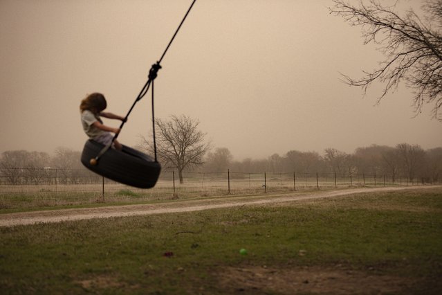 A child plays in a dust storm in Denton, Texas, on Friday, March 14, 2025. (Photo by Chris Rusanowsky/Zuma Press Wire/Rex Features/Shutterstock)