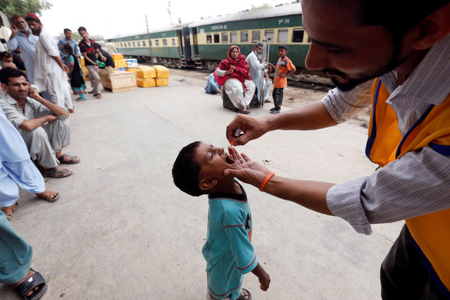 A boy receives polio vaccine drops at Cantonment Railway Station in Karachi, Pakistan, July 25, 2016. (Photo by Akhtar Soomro/Reuters)