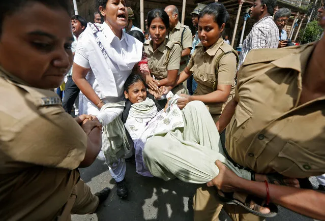 Police officers detain a demonstrator during a protest against what the demonstrators said was the rape and murder of a twelve-year old girl in Kolkata, India, September 1, 2016. (Photo by Rupak De Chowdhuri/Reuters)