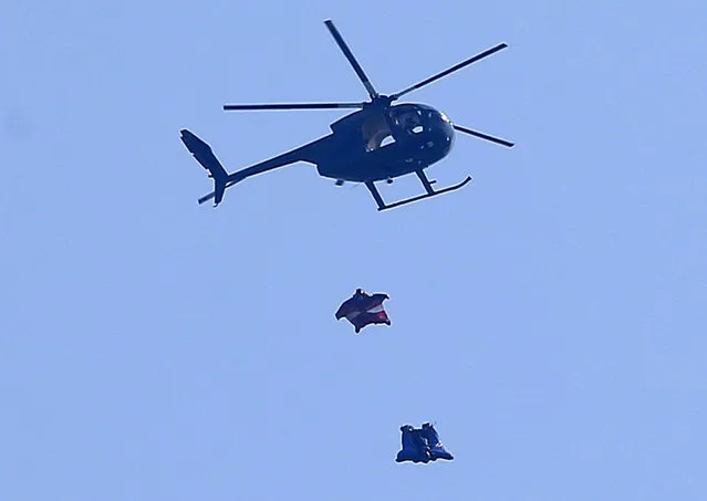 Stuntman Gary Connery is seen in the sky wearing a specially developed wingsuit near Henley-on-Thames, west of London May 23, 2012. He had jumped from a helicopter at 2,400 feet and successfully landed without the use of a parachute. (Photo by Eddie Keogh/Reuters)