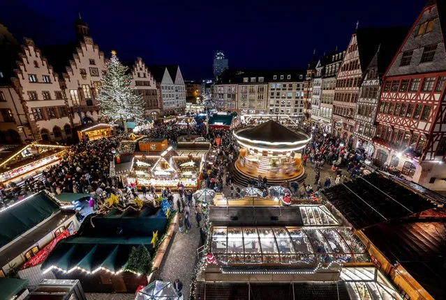 Lights illuminate the traditional Christmas Market that was opened in Frankfurt, Germany, Monday, November 21, 2022. (Photo by Michael Probst/AP Photo)