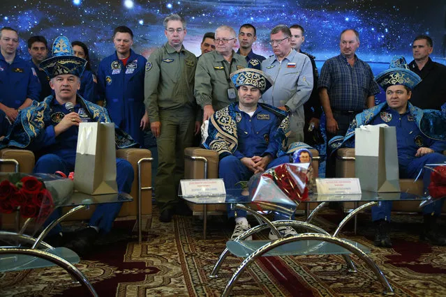 Former space crew of the International Space Station, US NASA astronaut Jeffrey Williams (L), Russian cosmonauts Alexei Ovchinin (C) and Oleg Skripochka (R) dressed in Kazakh national dress attend a press conference in Karaganda, after landing some 150 km east of the city of Dzhezkazgan in Kazakhstan, on September 7, 2016. An American astronaut who set the US record for cumulative time in orbit safely returned to Earth early on along with two Russian cosmonauts after a six-month mission aboard the International Space Station. NASA's Jeff Williams, 58, logged 534 days in space over four missions. The ISS commander landed at 7:13 local time (01:13 GMT) on the steppes of central Kazakhstan aboard a Russian-made Soyuz capsule along with Alexey Ovchinin and Oleg Skripochka. (Photo by Maxim Shipenkov/AFP Photo)