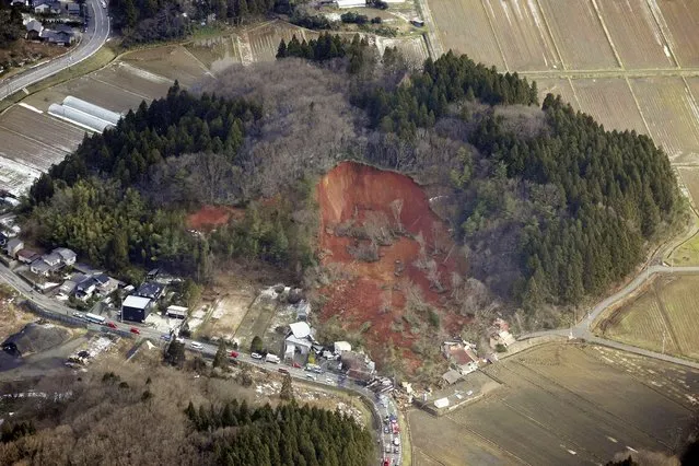 This aerial photo shows a landslide in Tsuruoka, Yamagata prefecture, north of Tokyo Saturday, December 31, 2022. A landslide swallowed about a dozen homes in northern Japan Saturday. (Photo by Kyodo News via AP Photo)