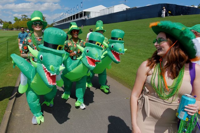 Austyn Scruggs, Alex Sutton and Josh Taylor, all sailors from NAS Jacksonville make their way down the 18th hole fairway in their St. Patrick's Day dragon costumes during the fourth and final round of The Players Championship PGA golf tournament at TPC Sawgrass in Ponte Vedra Beach, Fla. on March 17, 2024. (Phoot by Bob Self/Florida Times-Union via USA TODAY Network)