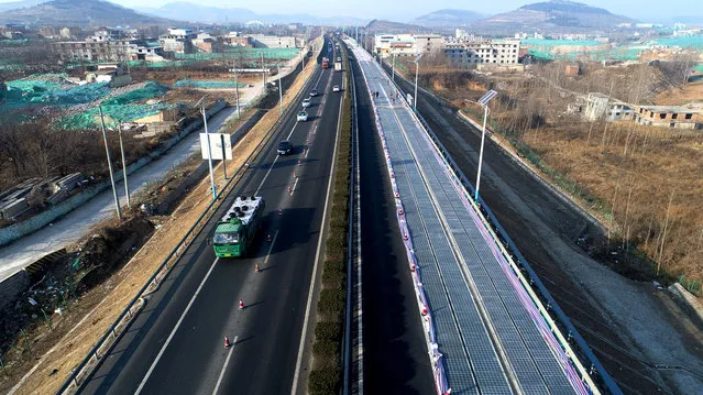 The photovoltaic road is under test on December 28, 2017 in Jinan, Shandong Province of China. World's first photovoltaic road has been finished construction and put into test run on Thursday in Jinan. The 2-kilometer-long photovoltaic road is built 1 kilometer east to the Jinan south toll station, and the electric it generates will be delivered to the nearby small power stations. The road with transparent concrete on top can bear the weight of small vehicles and medium trucks. (Photo by VCG/VCG via Getty Images)