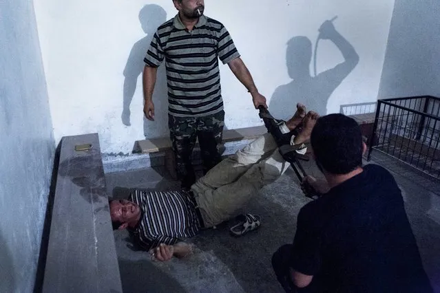 This picture by Turkish photographer Emin Oezmen won the 2nd Prize Spot News Single for “Interrogation” in the category “Spot News” in the 56th World Press Photo Contest, that was announced by the organizers on 15 February 2013 in Amsterdam, The Netherlands. Opposition fighters regularly launched operations to seize government informants after dark. Two informants were captured, declared guilty under interrogation, and tortured throughout the night; tired soldiers had to be replaced so the torture could continue. After 48 hours, the captives were released. The picture is dated 31 July 2012, in Aleppo, Syria. (Photo by Emin Oezmen/EPA)