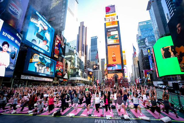 Yogis participate in a yoga class during the 23rd annual “Solstice in Times Square: Mind Over Madness Yoga” event to celebrate the summer solstice in New York City, on June 20, 2025. (Photo by Angelina Katsanis/Reuters)