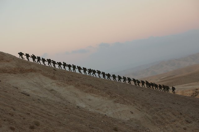 Newly-recruited soldiers of the Israeli Defence Forces (IDF) march during a 40-kilometer, 10-hour hike in Masada near the Dead Sea, Israel, May 29, 2025. (Photo by Xinhua News Agency/Rex Features/Shutterstock)