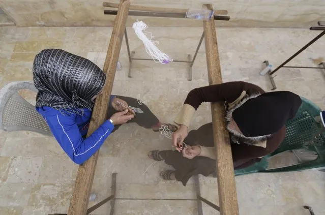 Women weave designs at a loom workshop in Jabal al-Zawiya November 23, 2014. (Photo by Khalil Ashawi/Reuters)