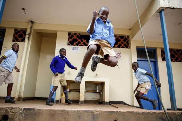 Schoolchildren joke around and play at the Olympic Primary School in Kibera, one of the capital Nairobi's poorest areas, in Kenya Monday, October 12, 2020. Kenya partially re-opened schools on Monday to allow those students due for examinations which had been postponed to prepare, following a total closure of all educational institutions enacted since March to curb the spread of the coronavirus pandemic. (Photo by Brian Inganga/AP Photo)