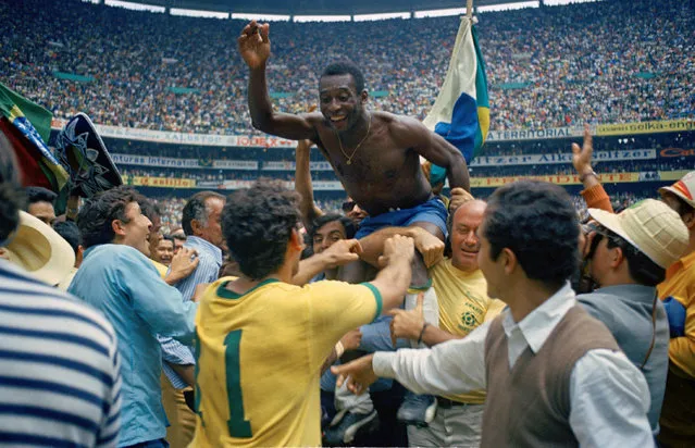 Brazil's Pele is hoisted on shoulders of his teammates after Brazil won the ninth World Cup final against Italy, 4-1, in Mexico City's Estadio Azteca, Mexico, on June 21, 1970.  Pele, who scored the opening goal of the game and assisted two, wins his third winner's medal.  The World Cup victory is Brazil's third win for the Jules Rimet Cup. (Photo by AP Photo)
