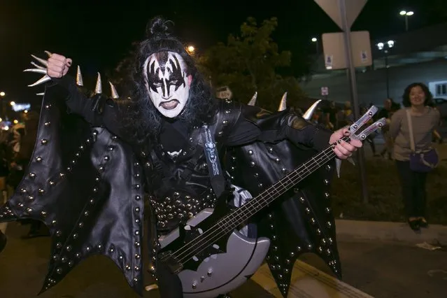 A man dressed as Gene Simmons from the rock group KISS poses at the West Hollywood Halloween Costume Carnaval, which attracts nearly 500,000 people annually in West Hollywood, California October 31, 2015. (Photo by Jonathan Alcorn/Reuters)