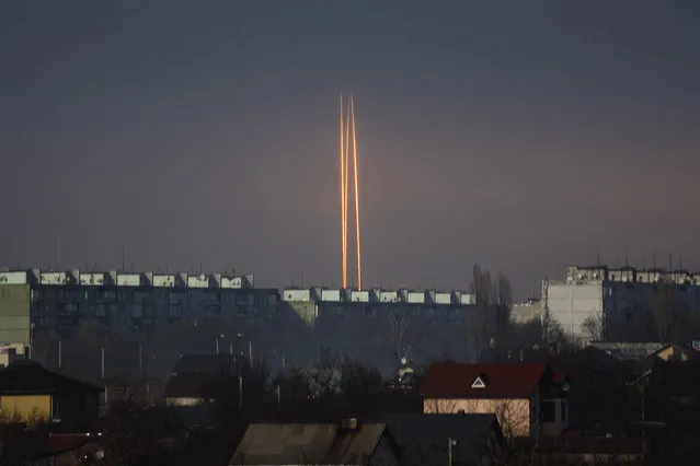 Three Russian rockets launched against Ukraine from Russia's Belgorod region are seen at dawn in Kharkiv, Ukraine, late Thursday, March 9, 2023. (Photo by Vadim Belikov/AP Photo)