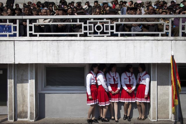 Members of the Korean Children's Union, bottom, chat while spectators take their seats at a stadium before a ceremony to induct children into the union, the first political organization for North Koreans, in Pyongyang, North Korea, Friday, April 12, 2013. (Photo by Alexander F. Yuan/AP Photo)