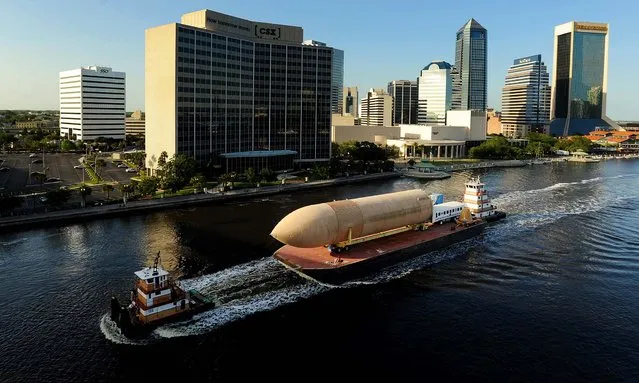 The last of NASA's space shuttle external fuel tanks makes it's way from the Kennedy Space Center down the St. Johns River through downtown Jacksonville, its way to the Wings of Dreams Aviation Museum in Keystone Heights, Florida, on April 26, 2013. The tank was used for testing and was never intended for space flights. (Photo by Bob Self/The Florida Times-Union)