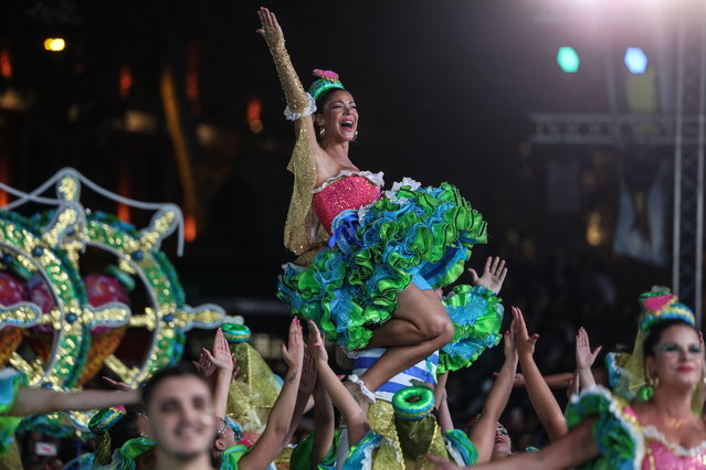 Fado singer Raquel Tavares performs during the March of Lisbon's “Marchas Populares” part of the Saint Anthony celebration at Liberdade Avenue in Lisbon, Portugal, 12 June 2024. Every year at Saint Anthony evening about 20 Lisbon neighborhoods march in colorful costumes and sing popular song in honor of the marriage saint. This evening is the most important festivity in Lisbon. (Photo by Tiago Petinga/EPA)