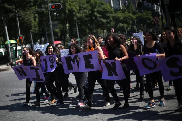 Activists block traffic to protest violence against women and the murder of a 16-year-old girl in a coastal town of Argentina last week, at Angel de la Independencia monument, in Mexico City, Mexico October 19, 2016. The sign reads, “Not one less”. (Photo by Edgard Garrido/Reuters)