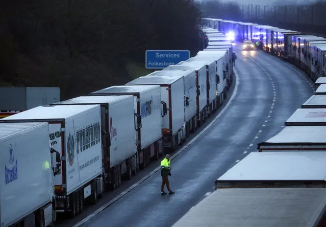 A drive sits in the cab of his lorry while parked on the M20 in Kent on December 2, 2020 after the Port of Dover was closed after the French government's announcement it will not accept any passengers arriving from the UK. France appears set to end a ban on hauliers crossing the Channel which was imposed due to fears about the spread of the new coronavirus strain. (Photo by Steve Parsons/PA Images via Getty Images)