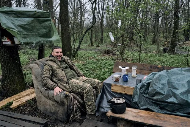 A Ukrainian soldier rests at his position on the frontline in Bakhmut, Donetsk region, Ukraine, Thursday, April 13, 2023. (Photo by Libkos/AP Photo)