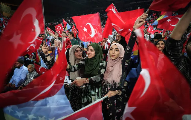 Supporters cheer and listen as Turkish President speaks during a  pre-election rally in Sarajevo, on May 20, 2018. Recep Tayyip Erdogan holds today the only election rally outside Turkey ahead of the June 24 presidential and parliamentary election. Sarajevo was chosen for the rally after several European Union countries, including Germany, banned such rallies in the campaign for last year's referendum on a new system enhancing the powers of the Turkish presidency. (Photo by Oliver Bunic/AFP Photo)