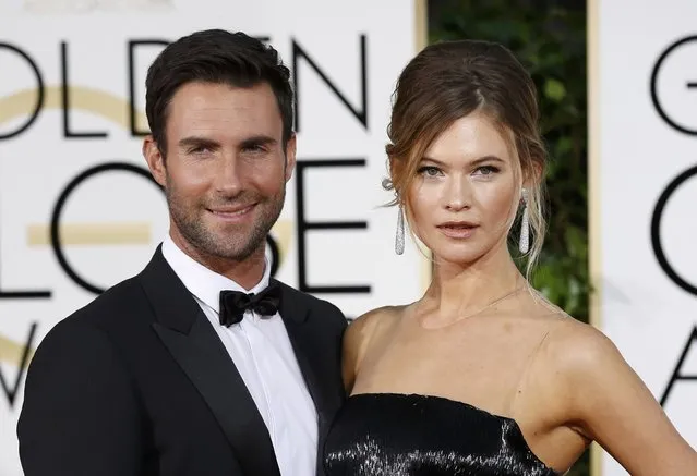 Maroon 5 singer Adam Levine arrives with his wife, model Behati Prinsloo, at the 72nd Golden Globe Awards in Beverly Hills, California January 11, 2015. (Photo by Mario Anzuoni/Reuters)