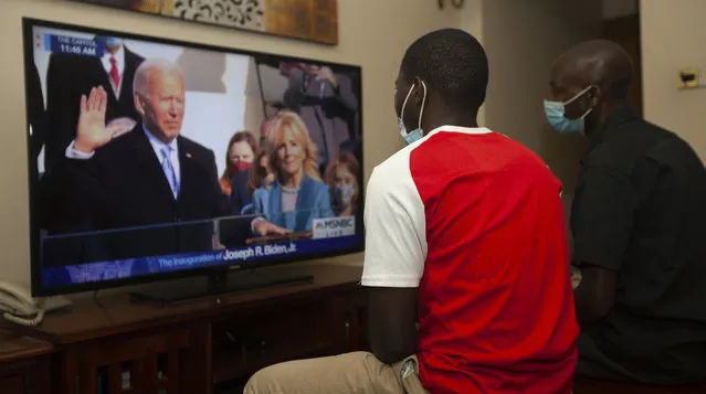 Kenyans watch President-elect Joe Biden's inauguration on the television, in Nairobi, Wednesday, January 20 2021. Biden has officially become the 46th president of the United States. (Photo by Sayyid Abdul Azim/AP Photo)