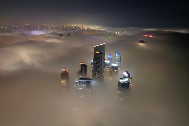 Aerial view of skyscrapers covered in fog in Buenos Aires on July 8, 2025. (Photo by Luis Robayo/AFP Photo)