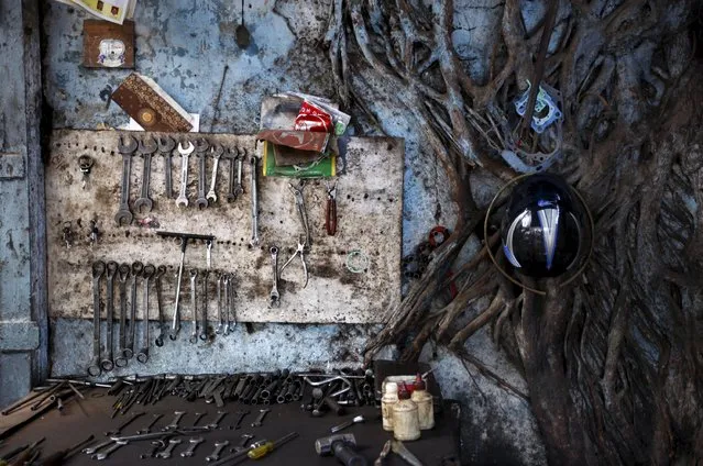 A mechanic's tools are seen on a table and on the wall in an auto workshop in Mumbai in this May 31, 2011 file photo. India is expected to release GDP figures this week. (Photo by Danish Siddiqui/Reuters)