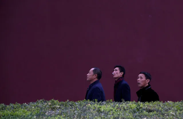 Men walk along a red wall near Tiananmen Gate on the first day of a plenary session of the 18th Central Committee of the Communist Party of China (CPC), in Beijing, China, October 24, 2016. (Photo by Jason Lee/Reuters)