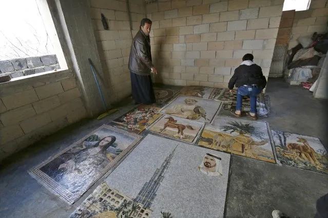 A man works on a mosaic artwork, copied from an original painting, in a workshop in Kafranbel town in the Idlib governorate January 17, 2015. (Photo by Khalil Ashawi/Reuters)