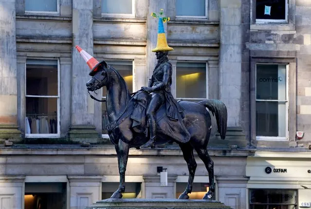 A traffic cone in the colours of the flag of Ukraine which has been placed on top of the Duke of Wellington statue in front of Gallery of Modern Art (GoMA), the former mansion of Lord William Cunninghame of Lainshaw, in Glasgow on Monday, March 7, 2022. (Photo by Andrew Milligan/PA Images via Getty Images)