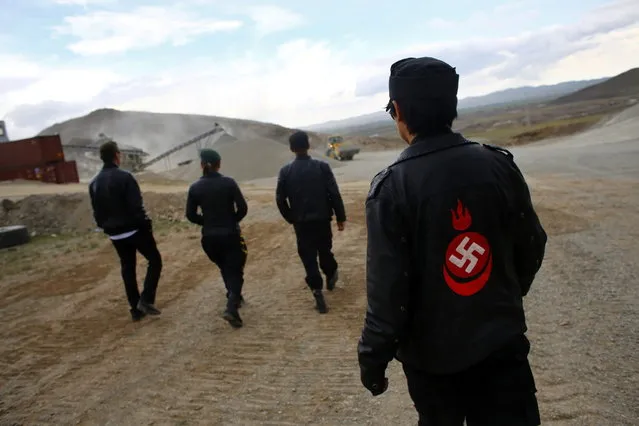 Members of the Mongolian neo-Nazi group Tsagaan Khass walk through a quarry, where they questioned a worker, southwest of Ulan Bator June 23, 2013. (Photo by Carlos Barria/Reuters)