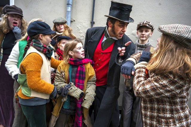 People in costumes from Charles Dickens' 19th-century English era take part in a Dickens Festival, in Deventer, Netherlands, Saturday, December 14, 2024. (Photo by Peter Dejong/AP Photo)