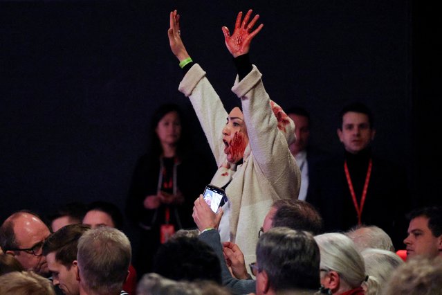 A protester shouts: “Free Palestine”, as German Chancellor Olaf Scholz visits a former locomotive shed and meets local citizens during the start of his Social Democratic (SPD) party election campaign tour, in Bielefeld, Germany, on January 13, 2025. (Photo by Wolfgang Rattay/Reuters)
