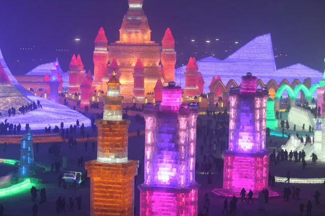 Tourists visit the 17th Harbin Ice And Snow World during its test run on December 22, 2015 in Harbin, China. (Photo by ChinaFotoPress/ChinaFotoPress via Getty Images)