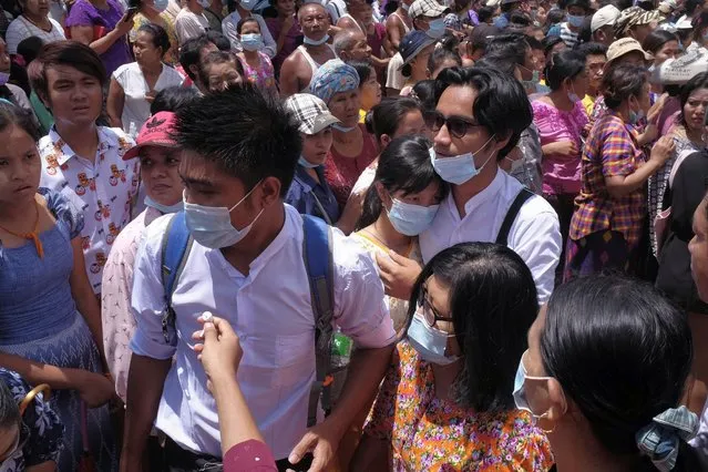 Zay Yar Lwin, center left in white, and Paing Pyo Min,center right in white, – both members of the Peacock Generation, a traditional theatrical troupe sentenced to prison in 2019 for their gibes about the military, walk through a crowd after their release from Insein prison in Yangon, Myanmar, Saturday, April 17, 2021. Myanmar's junta on Saturday announced it pardoned and released more than 23,000 prisoners to mark the new year holiday, but it wasn't immediately clear if they included pro-democracy activists who were detained in the wake of the February coup. (Photo by AP Photo/Stringer)