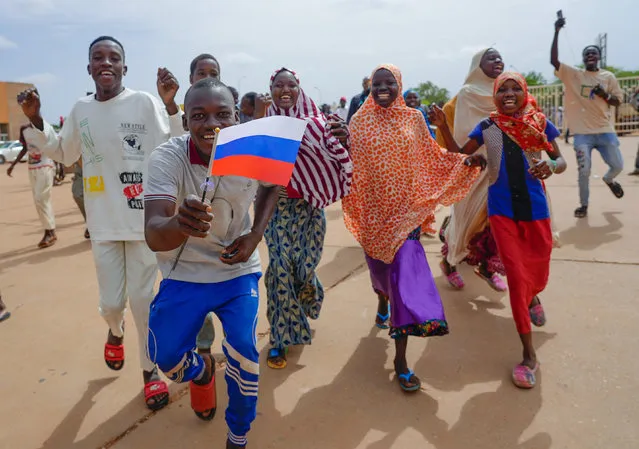 Supporters of Niger's ruling junta hold a Russian flag in Niamey, Niger, Sunday, August 6, 2023. Nigeriens are bracing for a possible military intervention as time's run out for its new junta leaders to reinstate the country's ousted president. (Photo by Sam Mednick/AP Photo)