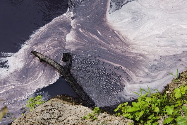 Factory waste including dyes from the many textile factories in the region drain into a tributary of the Citarum river on August 27, 2018 outside Bandung, Java, Indonesia. (Photo by Ed Wray/Getty Images)